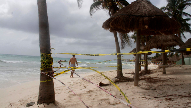 Tape closing off the beach blows in the wind before the arrival of Tropical Storm Zeta in Playa del Carmen, Mexico, Monday, Oct. 26, 2020. A strengthening Tropical Storm Zeta is expected to become a hurricane Monday as it heads toward the eastern end of Mexico's resort-dotted Yucatan Peninsula and then likely move on for a possible landfall on the central U.S. Gulf Coast at midweek. (AP Photo/Tomas Stargardter)