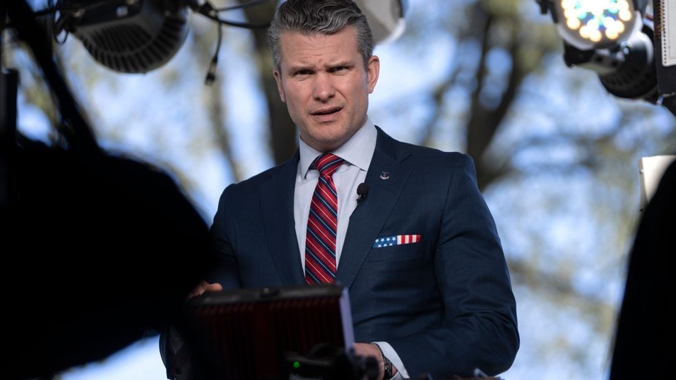 Defense Secretary Pete Hegseth prepares to give a television interview outside the White House, Friday, March 21, 2025, in Washington. (AP Photo/Mark Schiefelbein)