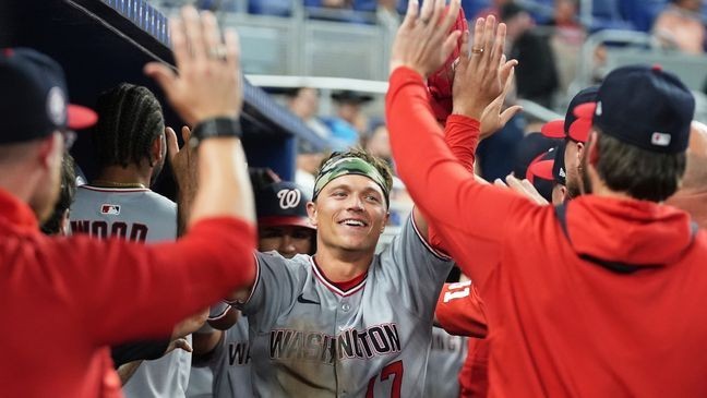 Washington Nationals' Alex Call is congratulated in the dugout after scoring on a double hit by Nathaniel Lowe during the eighth inning of a baseball game against the Miami Marlins, Friday, April 11, 2025, in Miami. (AP Photo/Lynne Sladky)