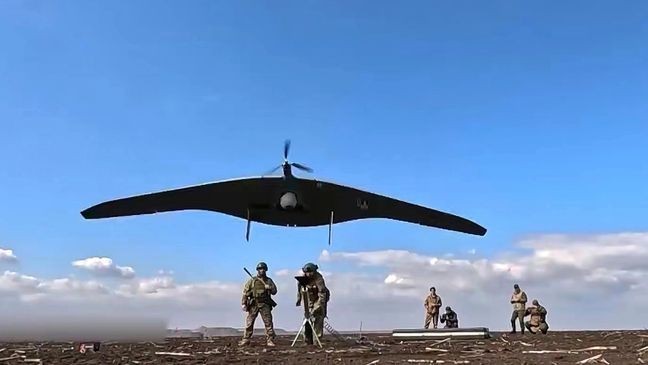 In this photo taken from video distributed by Russian Defense Ministry Press Service on Friday, April 18, 2025, Russian soldiers launch a Supercam intelligence unmanned aerial vehicle towards Ukrainian positions in Ukraine. (Russian Defense Ministry Press Service via AP)