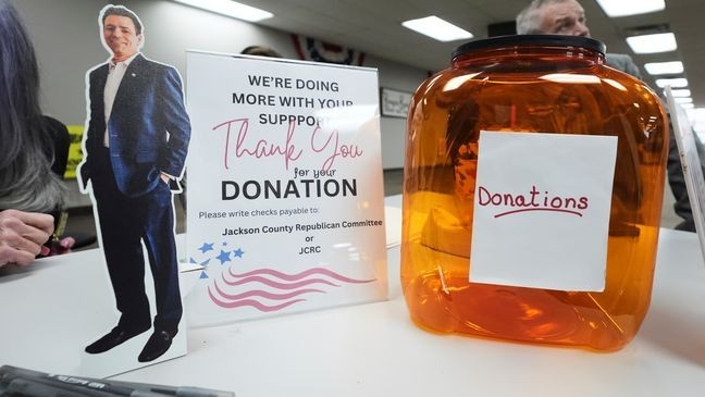 A small cutout of Ryan Kelley sits on the registration table before his talk at the Jackson County Republican headquarters, Thursday, April 10, 2025, in Jackson, Mich. (AP Photo/Paul Sancya)